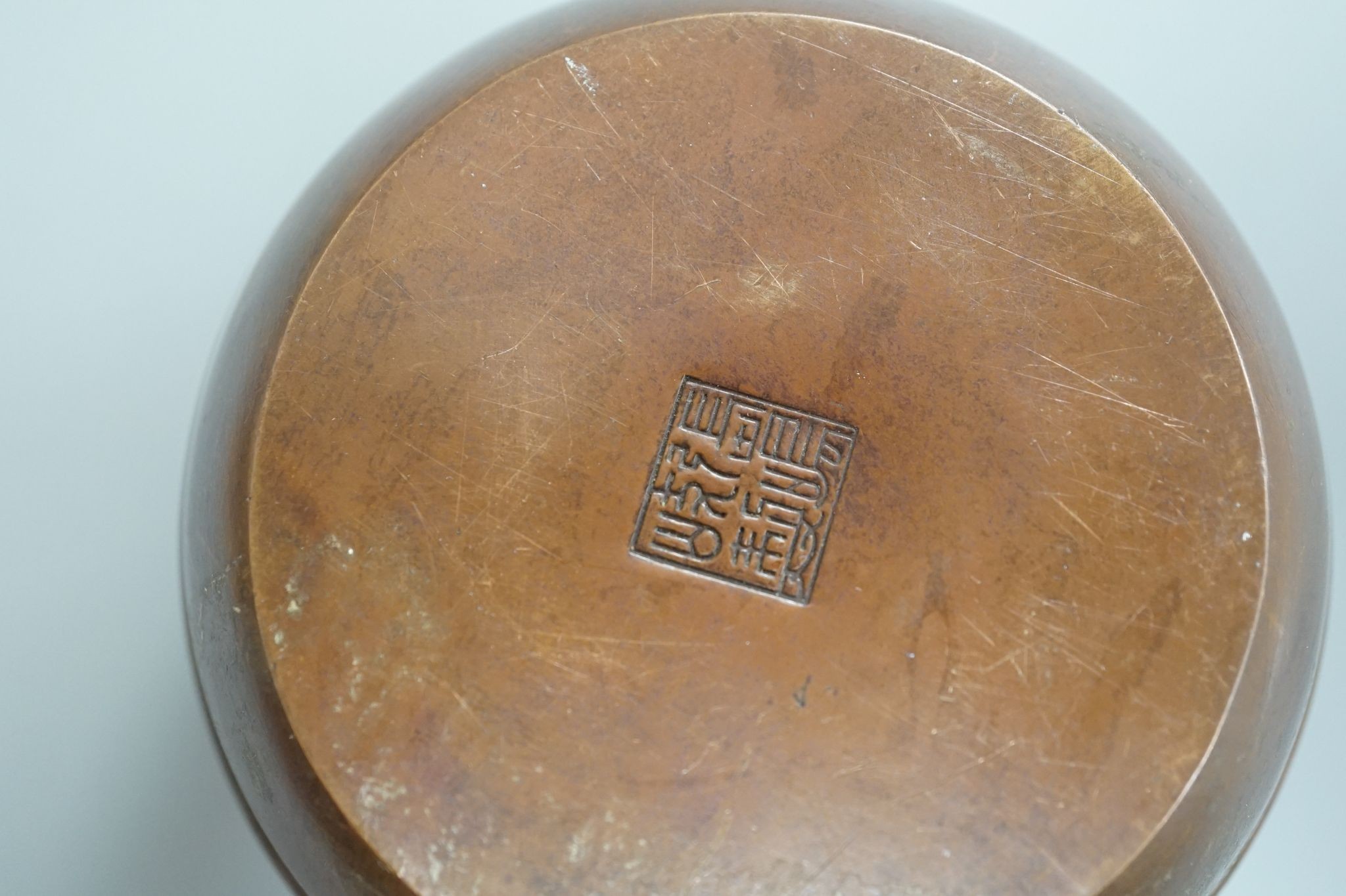 A Chinese bronze hand warmer, signed Zhang Mingqi 8cm diameter